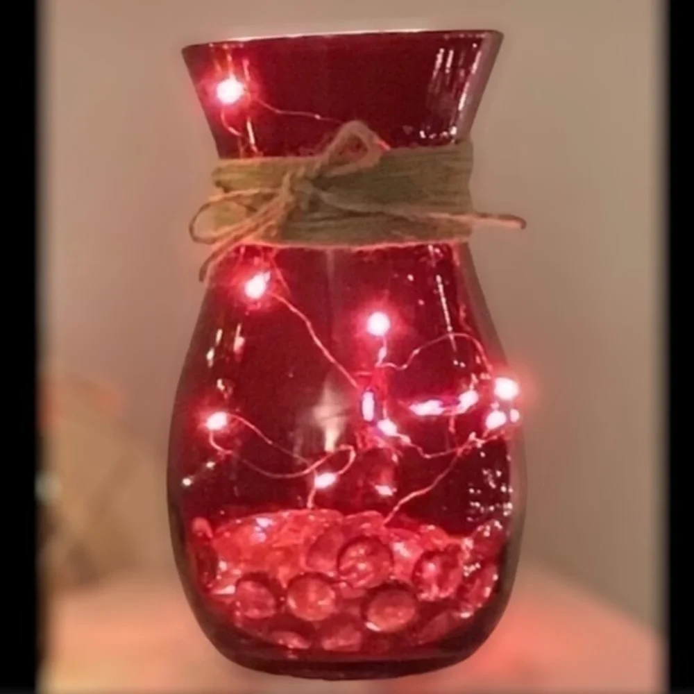 Red vase with string fairy lights